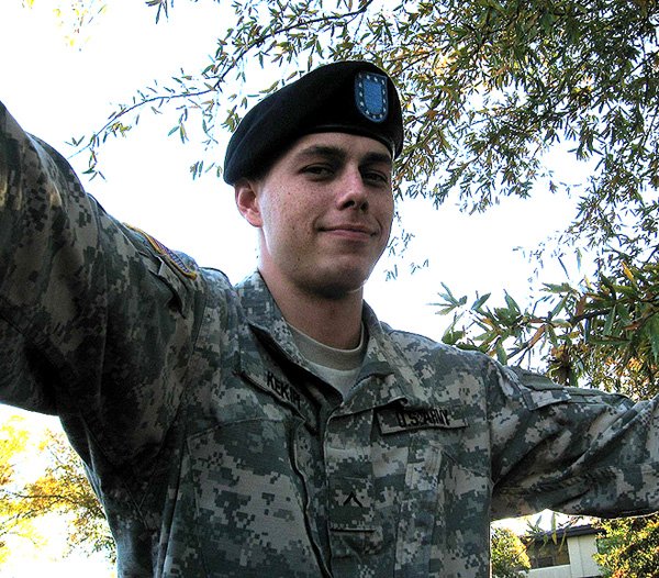 Daniel Kekipi wearing black beret and military jacket outdoors