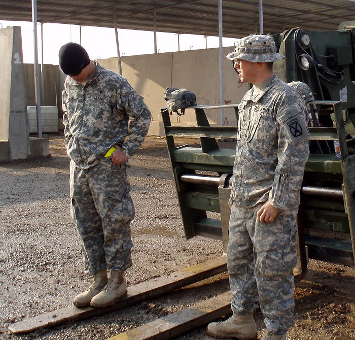 Daniel Kekipi and soldier Gifford standing near heavy equipment in Iraq