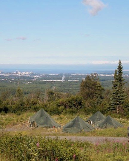 Tents set up at an army field campsite in Alaska overlooking Anchorage